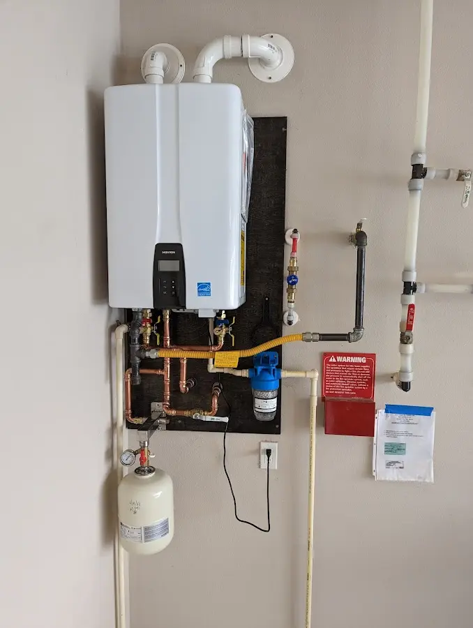 Professional plumber installing copper piping in a Chardon home
